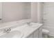 Bright bathroom features a marble countertop, double sinks, and a pristine white shower and toilet at 633 Kimberwick Dr, Locust Grove, GA 30248