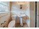 Full bathroom featuring white tile, white walls, toilet, and sink with pedestal at 1690 Carter Rd, Decatur, GA 30032