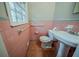 Small bathroom featuring pink tiling, a toilet, and a sink with a pedestal at 1690 Carter Rd, Decatur, GA 30032