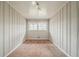 Empty bedroom features paneled walls, carpet flooring, and a window at 1690 Carter Rd, Decatur, GA 30032