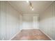 Empty bedroom featuring paneled walls, carpet flooring, and two doors at 1690 Carter Rd, Decatur, GA 30032