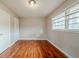 Bedroom with hardwood floors, one ceiling light, two windows, and one closet at 1690 Carter Rd, Decatur, GA 30032