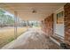 The carport leads to the main property entrance and exterior brick wall at 1690 Carter Rd, Decatur, GA 30032