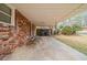 View of the property's covered carport and exterior brick wall at 1690 Carter Rd, Decatur, GA 30032