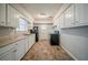 Functional kitchen with white cabinets, laminate countertops and black appliances at 1690 Carter Rd, Decatur, GA 30032