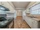 Spacious kitchen connects to a room with hardwood floors through an open doorframe at 1690 Carter Rd, Decatur, GA 30032