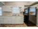 Kitchen featuring white cabinets, a double basin sink and black refrigerator at 1690 Carter Rd, Decatur, GA 30032