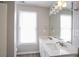 Bright bathroom featuring double sinks, granite counters, large mirror, and natural lighting at 3040 Washington Rd, Atlanta, GA 30344