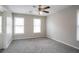 Empty bedroom with plush carpet, a ceiling fan, and plenty of natural light at 3040 Washington Rd, Atlanta, GA 30344