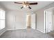 Spacious bedroom featuring plush carpeting, neutral walls and ceiling fan with light fixture at 3040 Washington Rd, Atlanta, GA 30344