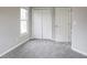 Clean bedroom featuring double closet doors, plush carpeting, and a bright window at 3040 Washington Rd, Atlanta, GA 30344