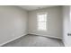 Cozy bedroom with neutral carpet, large window, and soft natural light at 3040 Washington Rd, Atlanta, GA 30344