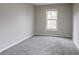 Neutral bedroom featuring plush gray carpeting, window, and soft natural light at 3040 Washington Rd, Atlanta, GA 30344