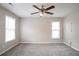 Spacious bedroom with plush carpet, neutral walls, and two bright windows at 3040 Washington Rd, Atlanta, GA 30344