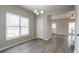 Bright dining room featuring modern gray flooring, contemporary light fixture, and a large window at 3040 Washington Rd, Atlanta, GA 30344