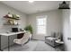 Comfortable home office featuring built-in shelves, a sleek desk, and an inviting armchair at 3040 Washington Rd, Atlanta, GA 30344