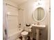 Bathroom with a tub, shower, round mirror, and a pedestal sink at 3601 Orchard Cir, Decatur, GA 30032