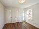 Bright bedroom featuring wood-look flooring and natural light from a large window at 3601 Orchard Cir, Decatur, GA 30032