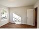 Sunny bedroom with wood-look flooring, a window view, and doorway at 3601 Orchard Cir, Decatur, GA 30032