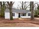 Cozy home exterior showcasing a blue door, white siding, black shutters, and a lawn covered in pine straw at 3601 Orchard Cir, Decatur, GA 30032