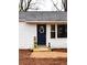 Close-up of front door with wreath, wooden steps, potted plants, and welcome sign, enhancing curb appeal at 3601 Orchard Cir, Decatur, GA 30032