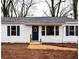 Quaint home featuring white siding, dark shutters, and a welcoming entrance with seasonal floral decorations and tidy landscaping at 3601 Orchard Cir, Decatur, GA 30032