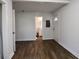 Living room featuring hardwood flooring, white walls, and a view to the bathroom and front door at 3601 Orchard Cir, Decatur, GA 30032