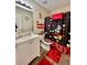 Bright bathroom with a single sink vanity, Mickey Mouse themed decor, and hardwood floors at 5509 Park Place South, Atlanta, GA 30349