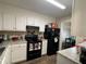 Functional kitchen with white cabinets, black appliances, and durable countertops at 5509 Park Place South, Atlanta, GA 30349