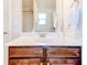 Bathroom vanity featuring quartz countertop, a mirror and dark wood cabinet at 6188 Riddle Ct, Douglasville, GA 30134