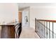 Hallway featuring a wooden display cabinet, decorative railing and carpet at 6188 Riddle Ct, Douglasville, GA 30134