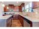 Well-equipped kitchen with granite countertops, modern appliances and dark wood cabinets at 6188 Riddle Ct, Douglasville, GA 30134