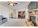 Open-concept living room with a stone fireplace that flows into the kitchen and dining area at 6188 Riddle Ct, Douglasville, GA 30134