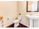 Stylish powder room featuring a pedestal sink, wood floors, and decorative accents at 6188 Riddle Ct, Douglasville, GA 30134