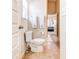 Bathroom featuring a toilet, two towel racks, a window for natural light, and beige floor at 6188 Riddle Ct, Douglasville, GA 30134