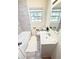 Clean bathroom featuring a tub/shower combo, white vanity, and a bright window at 2182 Rosewood Rd, Decatur, GA 30032