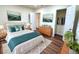 Bedroom with a queen bed, wooden dresser and art, bright interior at 2182 Rosewood Rd, Decatur, GA 30032
