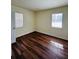 Bright bedroom with laminate floors, neutral paint, and sunlit windows at 2182 Rosewood Rd, Decatur, GA 30032