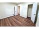 A bright bedroom featuring wood flooring, white walls, and an open closet at 2182 Rosewood Rd, Decatur, GA 30032