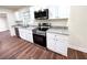 Close-up of sleek kitchen with granite counters, stainless appliances, and white cabinetry at 2182 Rosewood Rd, Decatur, GA 30032