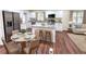 Modern eat-in kitchen with white cabinets, stainless appliances and dining table at 2182 Rosewood Rd, Decatur, GA 30032