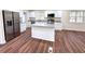 Modern kitchen with white cabinets, stainless appliances and a large granite island at 2182 Rosewood Rd, Decatur, GA 30032