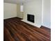 Comfortable living room with a painted brick fireplace, neutral paint, and laminate floors at 2182 Rosewood Rd, Decatur, GA 30032