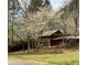 A well-maintained home with a red door nestled among flowering trees at 3315 Canterbury Trl, Rex, GA 30273