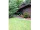 Exterior shot of home showing mature trees, brown siding, and a pathway to the entrance at 3315 Canterbury Trl, Rex, GA 30273