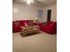 View of the living room area with carpeted floors, bright walls, and a red sofa set at 3315 Canterbury Trl, Rex, GA 30273