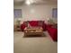 View of the living room area with carpeted floors, bright walls, and a red sofa set at 3315 Canterbury Trl, Rex, GA 30273