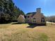 Spacious backyard featuring the home's rear exterior and a well-maintained lawn at 3650 Burnt Hickory Dr, Dacula, GA 30019