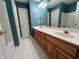 Large bathroom with a double vanity and an expansive mirror at 3650 Burnt Hickory Dr, Dacula, GA 30019