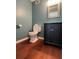 This bathroom offers a modern vanity, toilet, and dark wood floors at 3650 Burnt Hickory Dr, Dacula, GA 30019